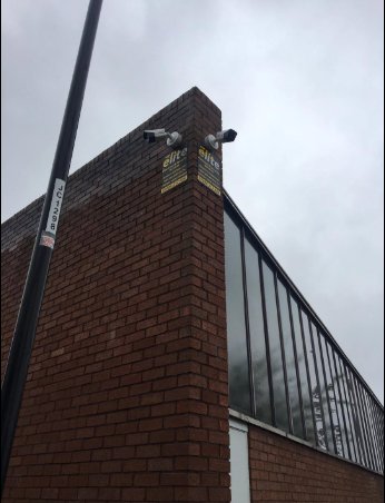 Two CCTV cameras covering both sides of a building corner
